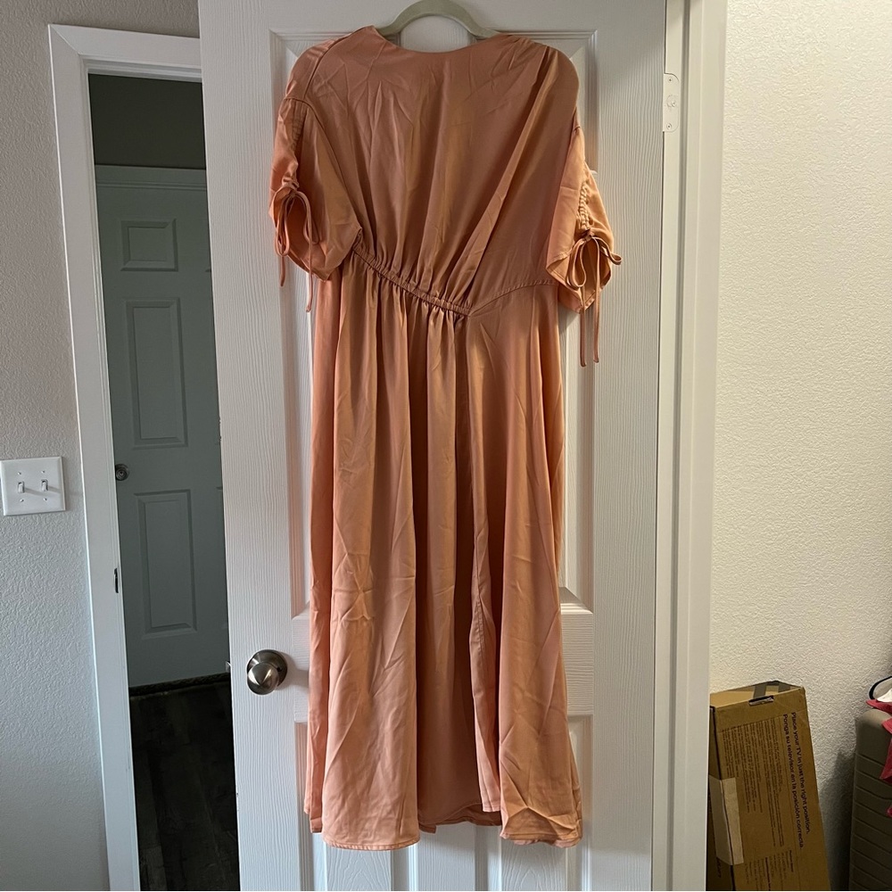 Peach satin midi dress with ties on the sleeves